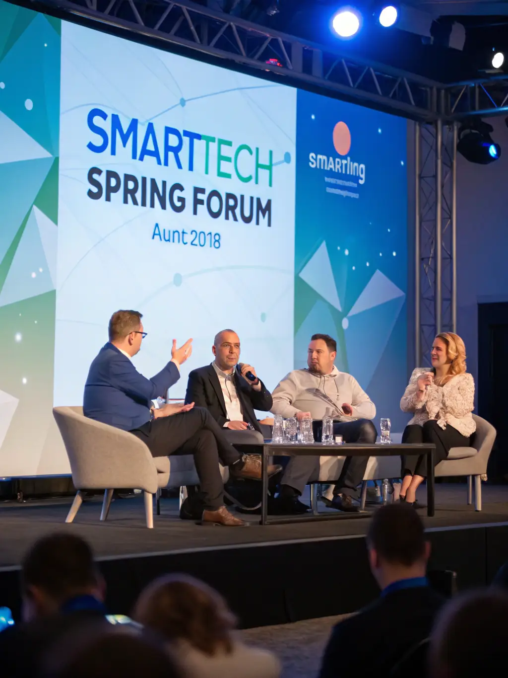 A dynamic image of a panel discussion at the Innovations Summit, featuring industry experts debating the future of fintech in India.